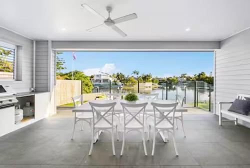 a dining room with a table and chairs at Capri Waterfront Resort-Style 5BR & Pool in Gold Coast