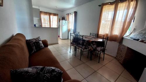 a living room with a couch and a table and chairs at Casas El Timón A in Chuí