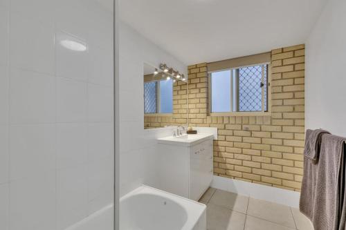 a bathroom with a sink and a glass shower at North Facing 2 Bedroom Apartment at Cotton Tree in Maroochydore
