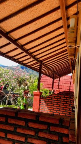 a wooden roof on a building with a view of a hill at Eco Moringa Garden in Banyuwedang