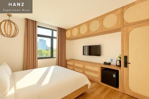 a bedroom with a large bed and a tv at S79 Good and Good Grand World in Phu Quoc