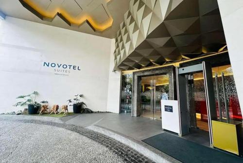 a building with a novoiced smiles sign on the wall at Novotel Rockwell View Hotel Residences in Manila