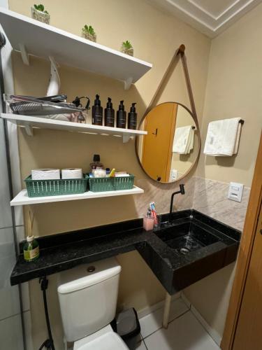 a bathroom with a sink and a mirror at Novo, decorado e perto de tudo in Ananindeua
