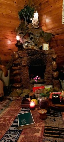 a living room with a fireplace and a book on the floor at The Sound Of Silence Homestay Đà Lạt in Da Lat