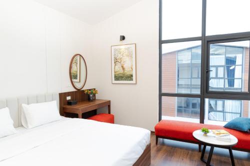 ein Schlafzimmer mit einem Bett und einem Stuhl und einem Fenster in der Unterkunft MYAN Villa Phòng nghỉ 5 có sân sau Vinhomes Ocean Park 3 in Ðình Loan