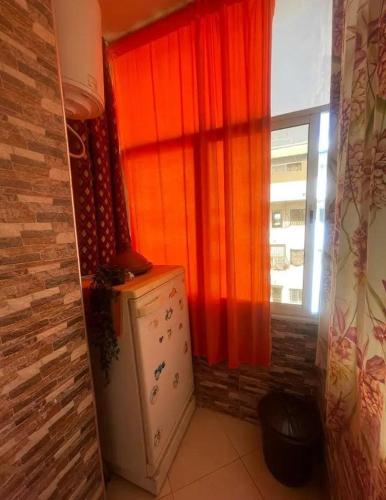 a kitchen with a refrigerator in front of a window at Appartement rénové Agadir in Agadir