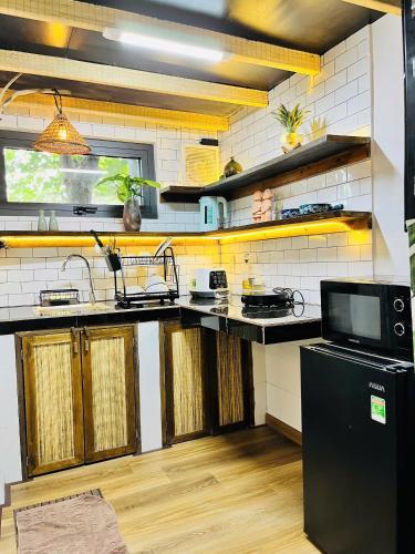 a kitchen with a black and white counter top at TỊNH Retreat Phu Quoc in Phu Quoc