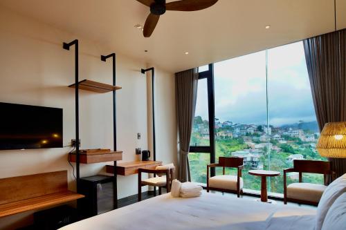 a hotel room with a bed and a large window at Là Yên Villa - Đà Lạt in Ấp Ða Lợi