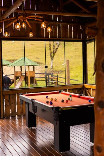 a pool table in the middle of a room at Cabanas Recanto das Lagoas in Bom Retiro
