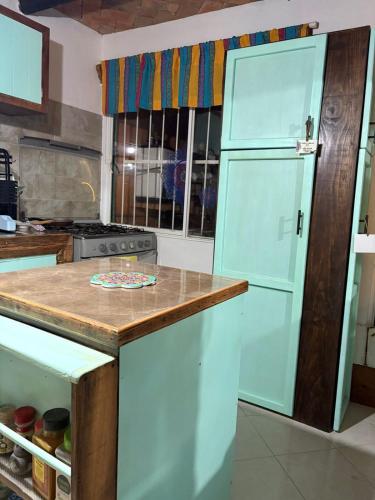 a kitchen with a large white refrigerator in a kitchen at Espacios Livemarlu casa de huéspedes in Coatepec
