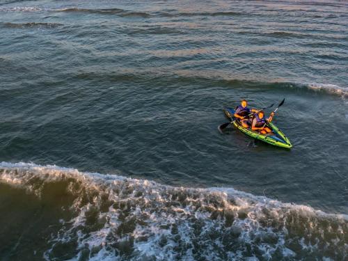 a group of people in a boat in the water at Beach Stayz Semaphore Three Bedroom Apartment in Port Adelaide