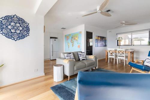 a living room with a couch and a table at Beach Stayz Semaphore Upstairs Two Bedroom Apartment in Port Adelaide