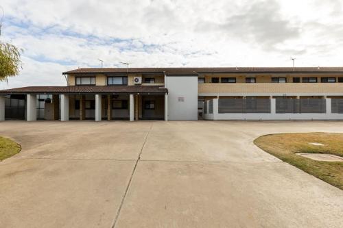 a building with a large driveway in front of it at Beach Stayz Semaphore Upstairs Two Bedroom Apartment in Port Adelaide
