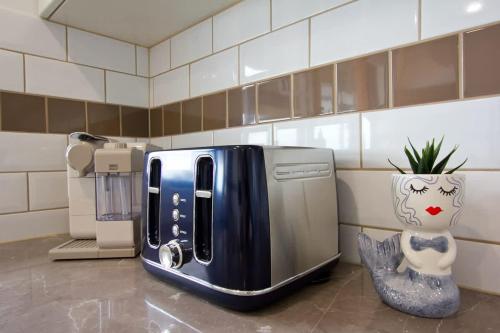 a toaster sitting on a counter in a kitchen at Beach Stayz Semaphore Upstairs Two Bedroom Apartment in Port Adelaide