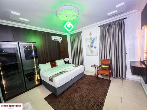 a bedroom with a bed and a green ceiling at Kings Heights Apartments in Ikeja