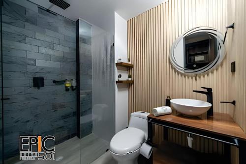 a bathroom with a toilet and a sink and a mirror at Epic Suite 501 Deluxe Aeropuerto in Cuba