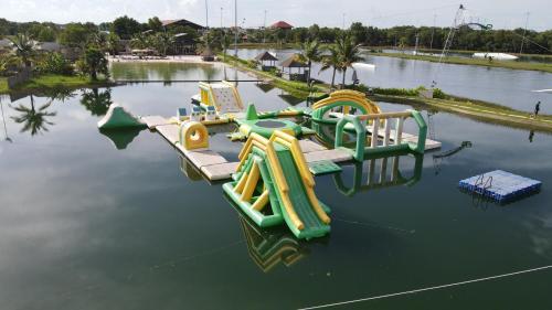 a group of slides in the water at a water park at Wake Park Cambodia in Siem Reap
