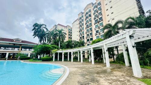 a resort with a swimming pool and a building at Terravive in Manila