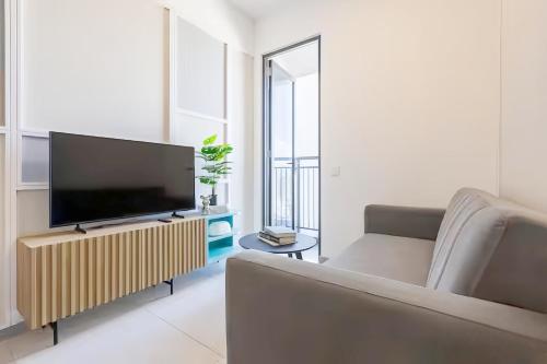 a living room with a television and a couch at 22 Macalisterz George Town in George Town
