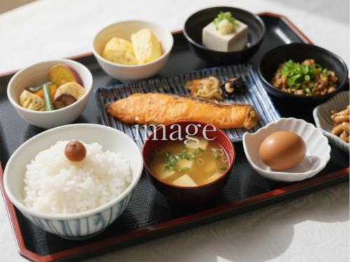 a tray of food with rice and eggs and other foods at APA Hotel Takasakieki Higashiguchi in Takasaki