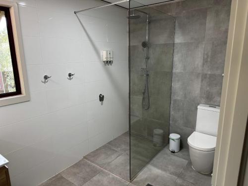 a bathroom with a shower and a toilet at 718 Cooloola Villa at Kingfisher Bay, K'gari Fraser Island in K'gari Island (Fraser Island)