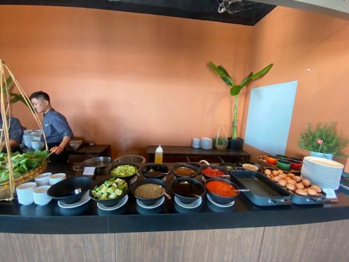 a table with many different types of food on it at Condotel SeaSide - Apec Mandala Cham Bay Mui Ne in Mui Ne