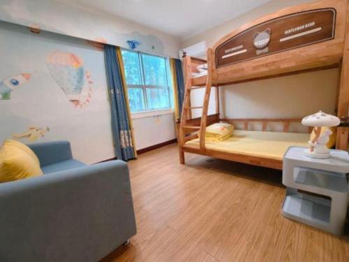 a room with two bunk beds and a couch at Catic Hotel--Adjacent Buliding in Zhuhai