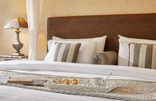 a bed with a tray of food on it at Limneon Resort & Spa in Kastoria