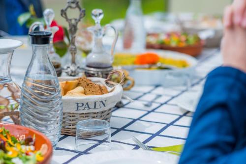a table with a bowl of food and a bottle of water at Château d’Orion in Orion