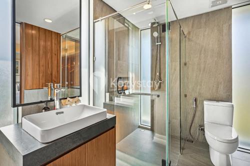 une salle de bain avec un lavabo, des toilettes et une douche dans l'établissement Andra Villa by Kozystay - Natadesa Resort Jimbaran, à Jimbaran