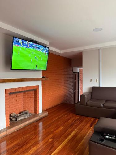 a living room with a fireplace and a flat screen tv at Harmony Hotel by Haven in San José