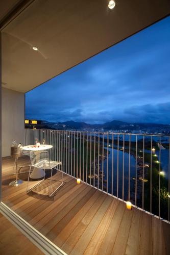 a balcony with a table and a view of the city at Garden Terrace Nagasaki Hotels & Resorts in Nagasaki