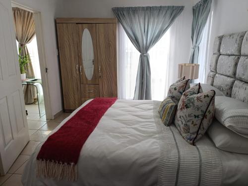 a bedroom with a large bed and a window at Long on Hill in Johannesburg