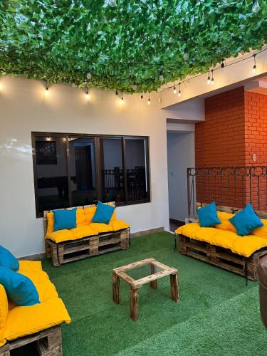 a living room with yellow couches and a table at Harmony Hotel by Haven in San José
