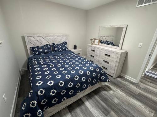 a bedroom with a bed and a large mirror at Modern Family Home -3BR -High Speed Wi-Fi Comfort in Sterling Heights