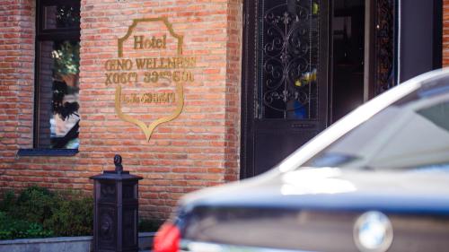 a sign on the side of a brick building at Hotel Gino Wellness Mtskheta in Mtskheta