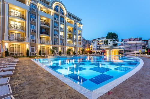 a hotel with a swimming pool in front of a building at Rena Hotel - All Inclusive in Sunny Beach