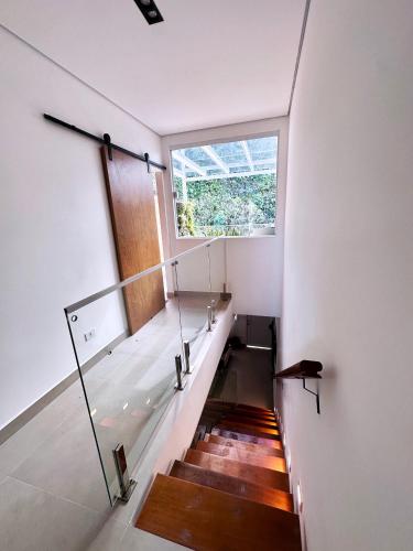 a staircase in a house with a window at Juquehy - Duplex in prime area 1 block from the beach in Juquei