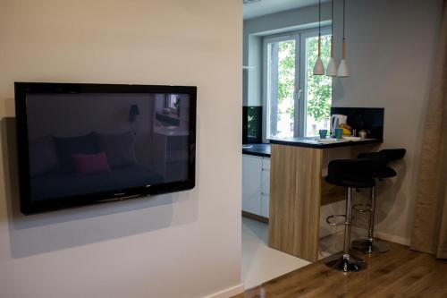 a living room with a flat screen tv on a wall at A3XD Apartament in Częstochowa