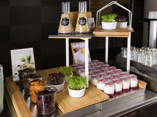 a display with plants in pots on a shelf at Novotel Chennai Chamiers Road in Chennai