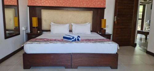 a bedroom with a large bed with a blue box on it at Amara White Villa in Ahungalla