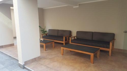 two benches and a table in a room at Apartamento Reyes Catolicos in Salta