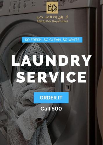 a poster for a laundry service in front of a washing machine at Abraj INN Royal Hotel فندق أبراج إن الملكي in Doha