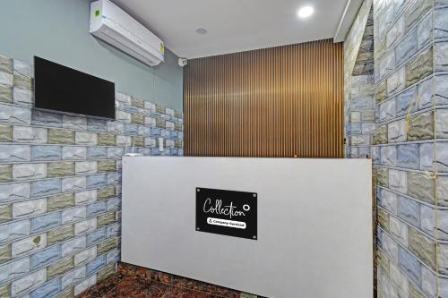 a lobby with a sign on a wall at Super Collection O White Field Road Hyderabad Formerly Ayaan Signature Suites in Kondapur