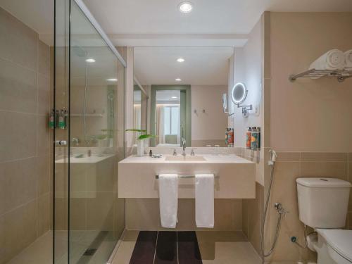 a bathroom with a sink and a shower and a toilet at Grand Mercure Rio de Janeiro Copacabana in Rio de Janeiro