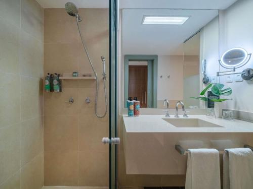 a bathroom with a sink and a shower at Grand Mercure Rio de Janeiro Copacabana in Rio de Janeiro