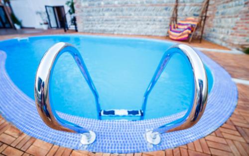 a pair of sunglasses sitting on top of a swimming pool at Hotel Gino Wellness Mtskheta in Mtskheta