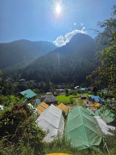 a view of a village with mountains in the background at Jalpa Camp Kasol in Kulu