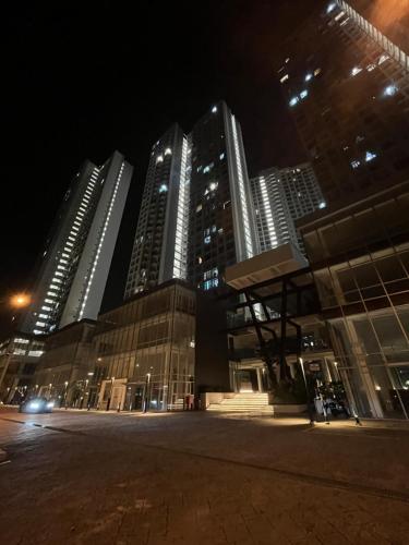 a group of tall buildings in a city at night at Arissa Homestay Midas Seri Alam in Masai
