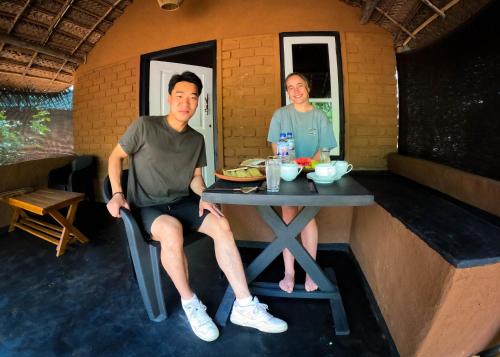 a man and a woman sitting at a table in a room at Safaria Lodge Wilpattu in Pahala Maragahawewa